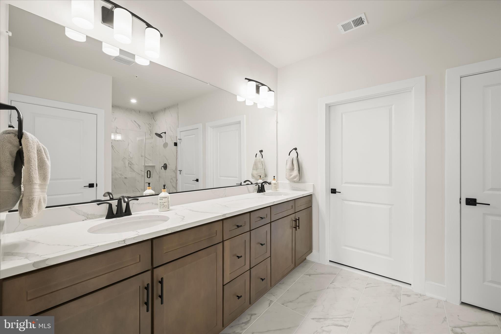 8104 Lisa Lane Fulton, MD 20759 - Photo 20 of 54 a bathroom with a double vanity sink mirror and double