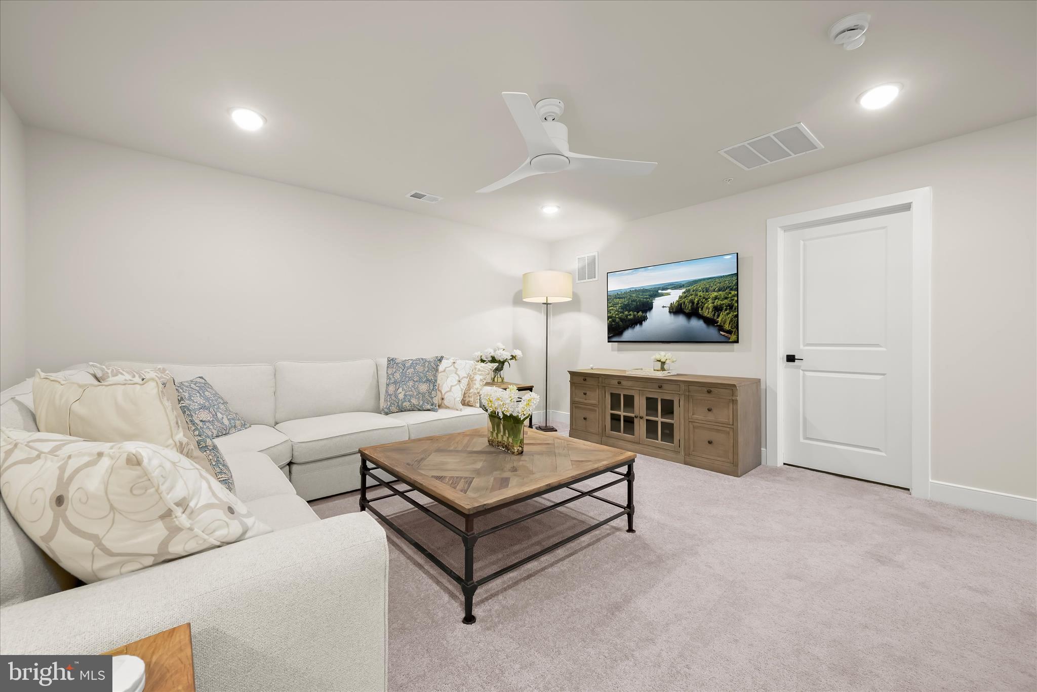 8104 Lisa Lane Fulton, MD 20759 - Photo 24 of 54 a living room with furniture and a flat screen tv