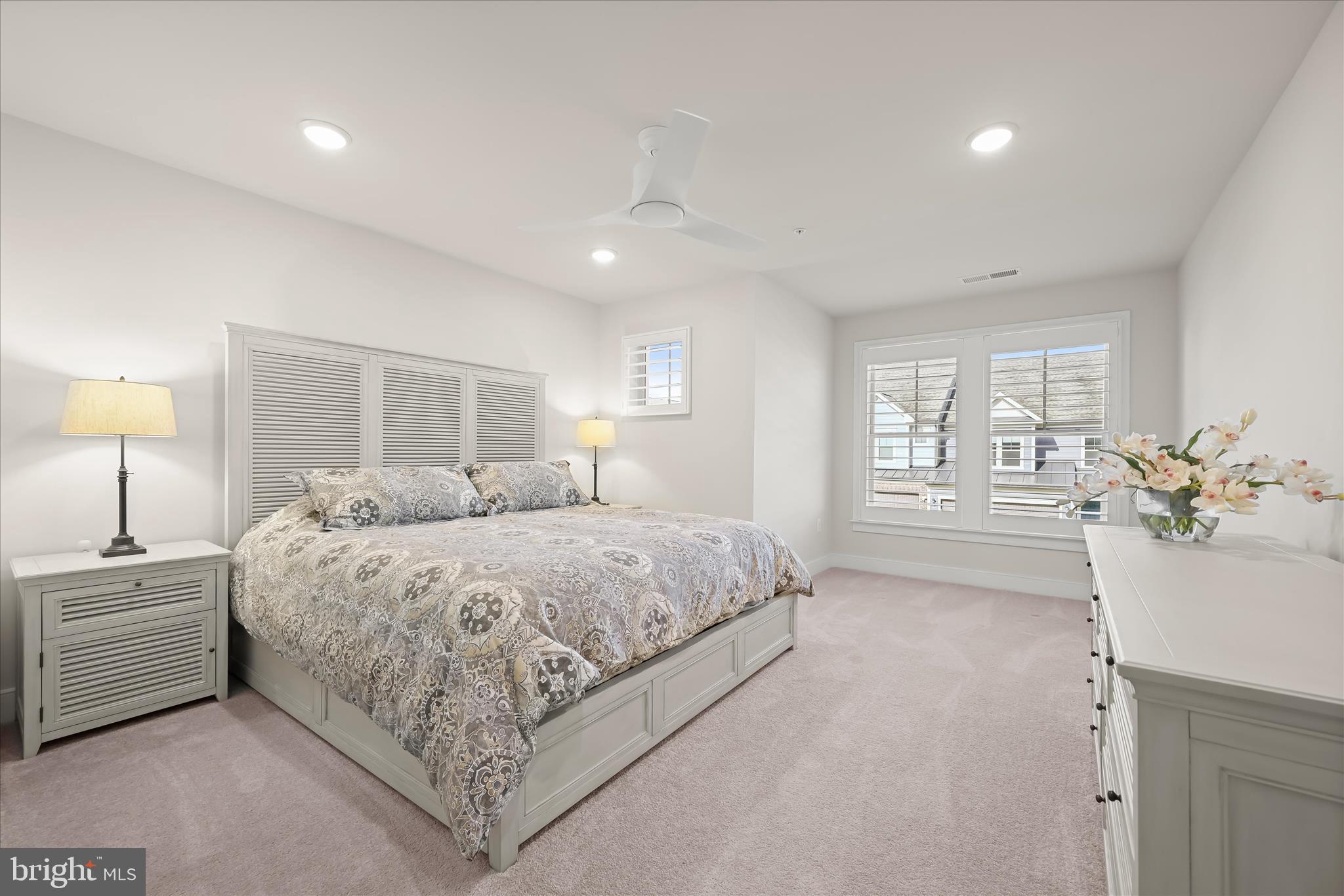 8104 Lisa Lane Fulton, MD 20759 - Photo 26 of 54 a spacious bedroom with a large bed and a chandelier