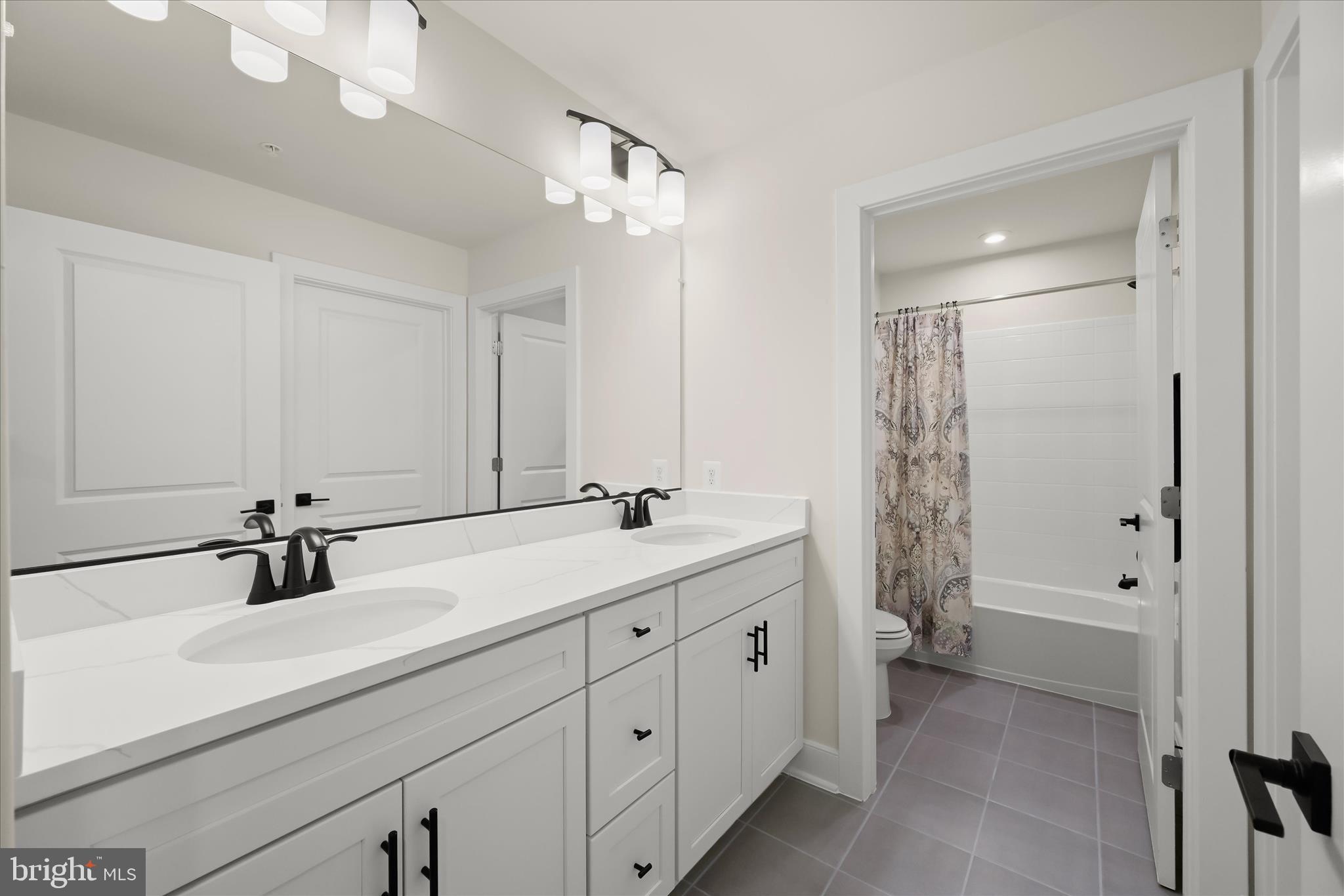 8104 Lisa Lane Fulton, MD 20759 - Photo 28 of 54 a bathroom with double sink and a mirror