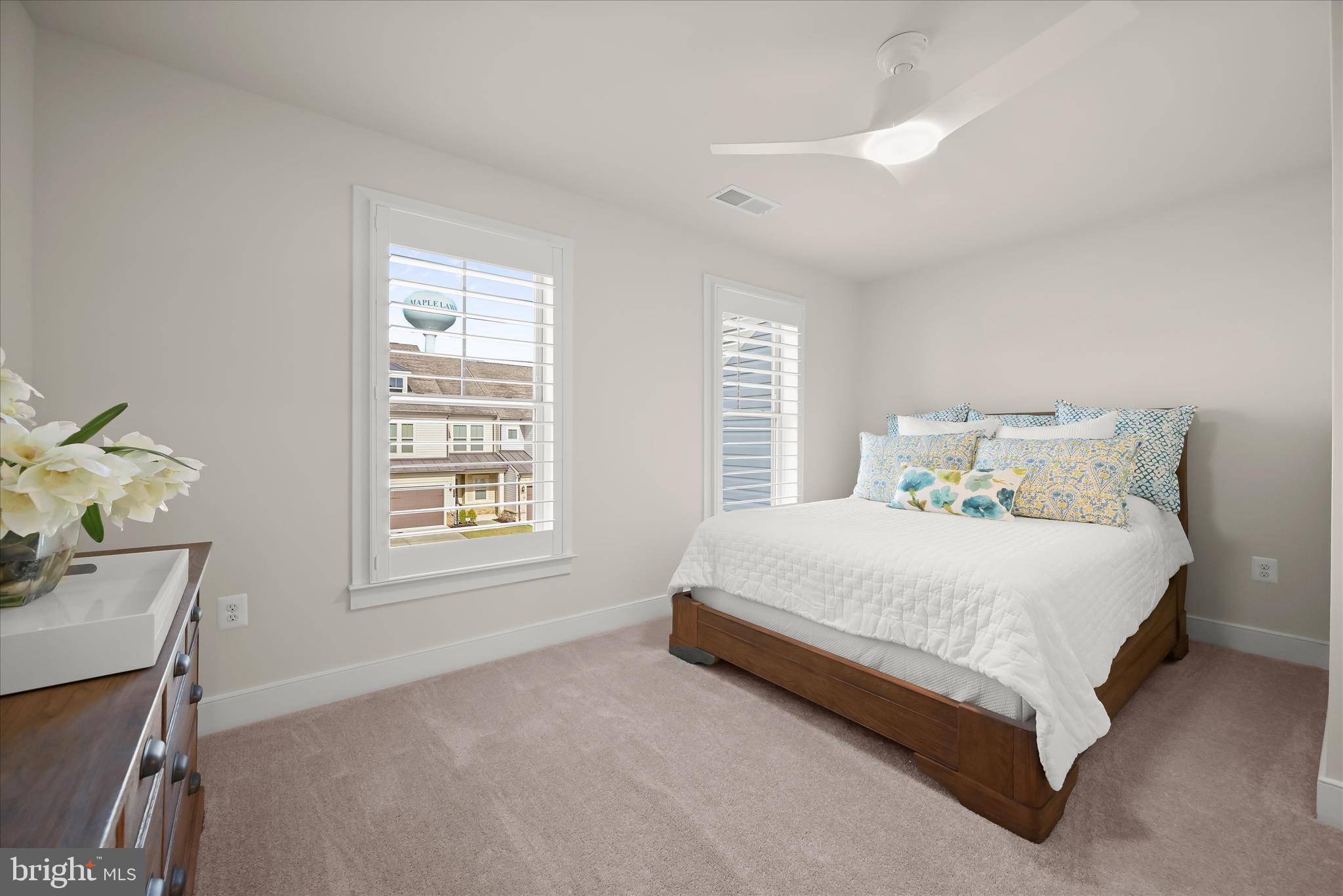 8104 Lisa Lane Fulton, MD 20759 - Photo 29 of 54 a bedroom with a bed a window and flowerpot