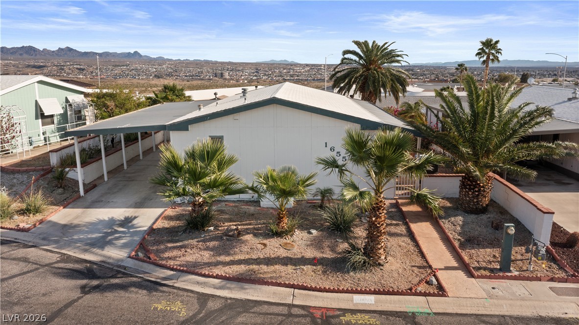 1655 Granada Street Laughlin, NV 89029 - Photo 53 of 76 View of front facade with a mountain view, concrete driveway, and an attached carport