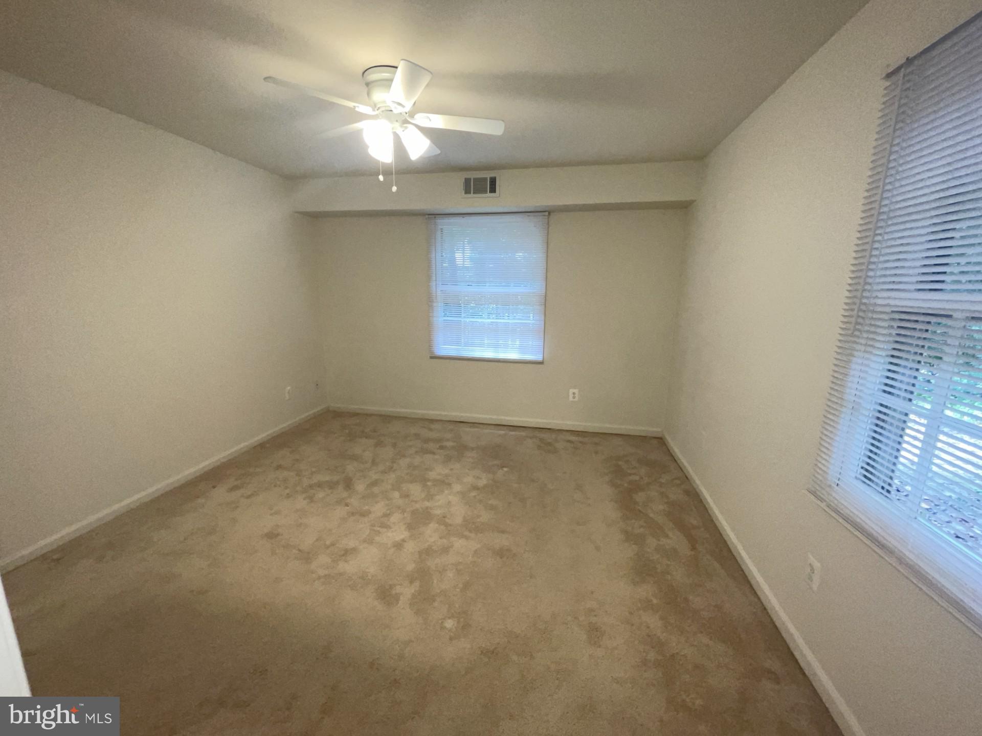5904 L Bayshire Road, Unit L Springfield, VA 22152 - Photo 14 of 40 an empty room with windows and fan