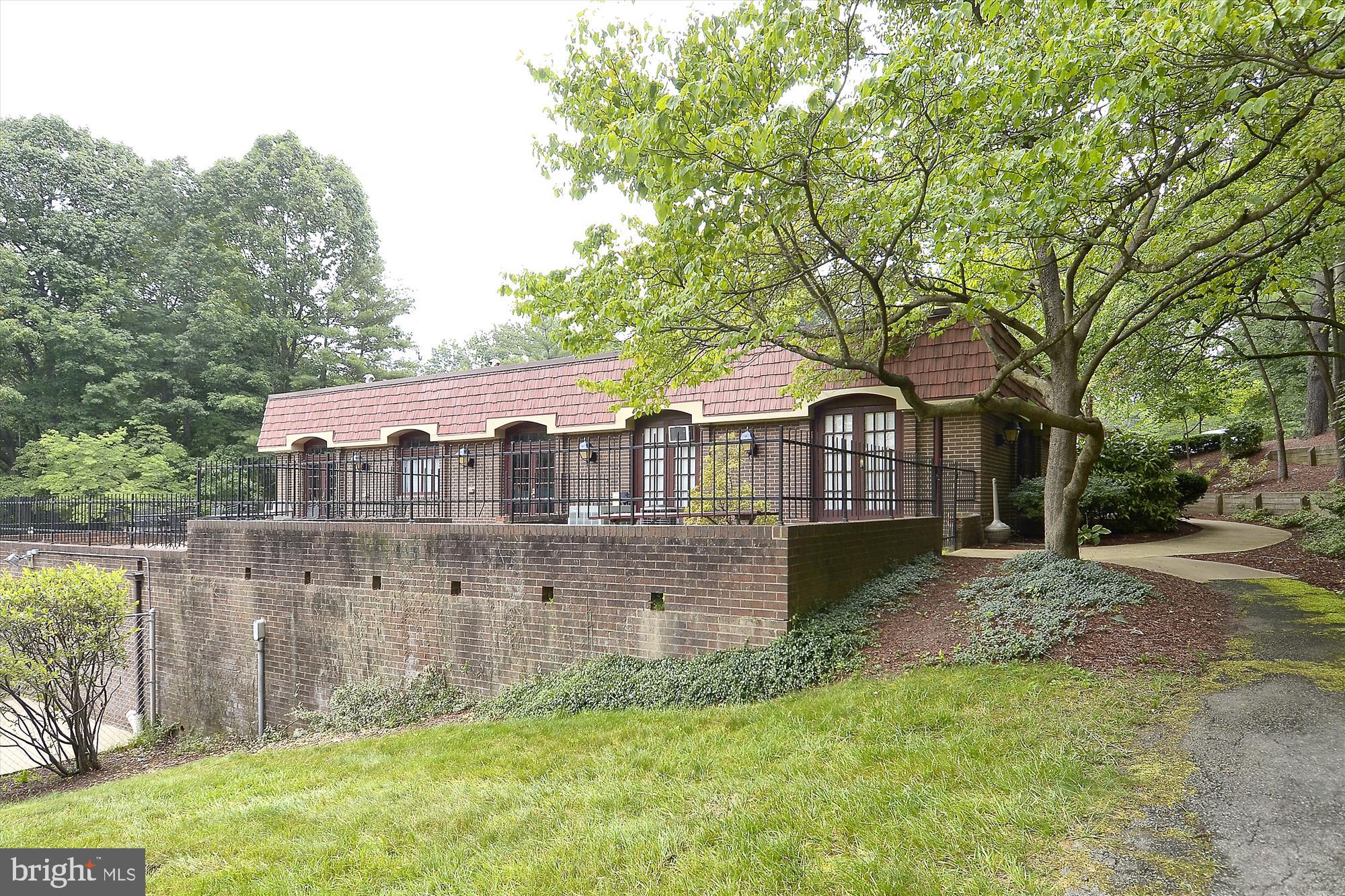 5904 L Bayshire Road, Unit L Springfield, VA 22152 - Photo 32 of 40 a front view of a house with garden