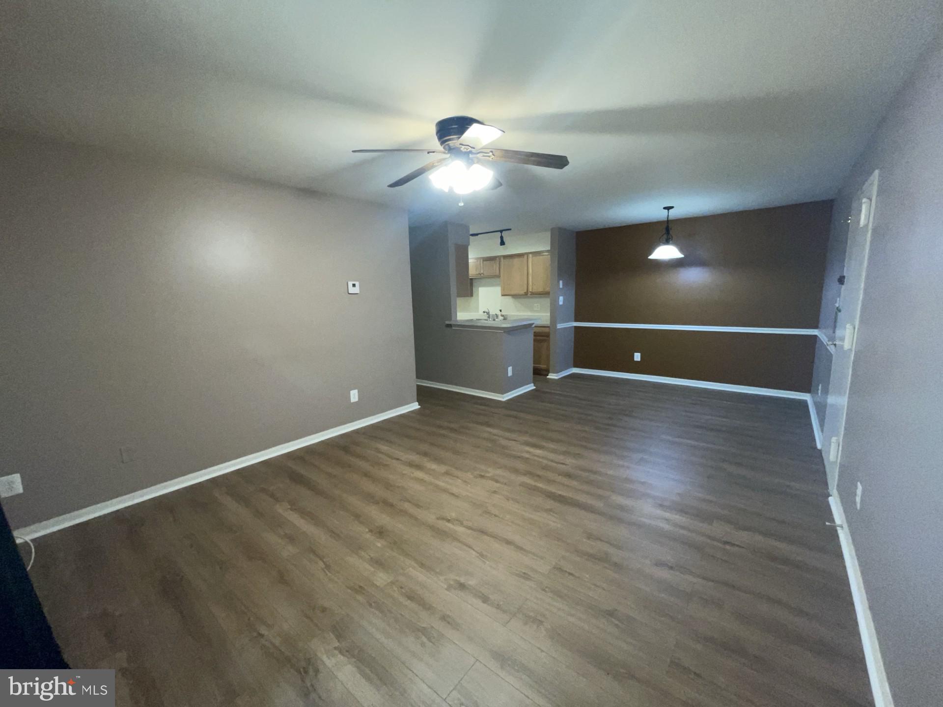 5904 L Bayshire Road, Unit L Springfield, VA 22152 - Photo 7 of 40 an empty room with wooden floor and windows