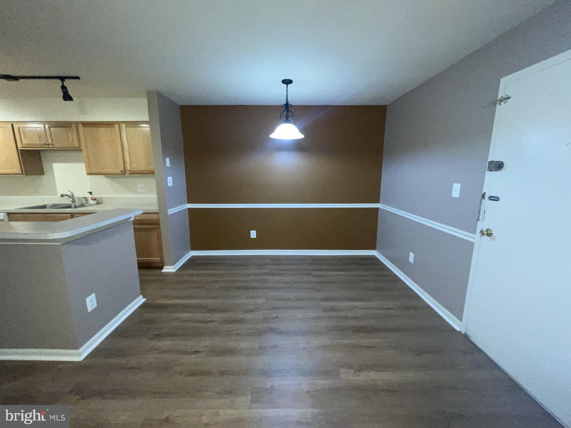 5904 L Bayshire Road, Unit L Springfield, VA 22152 - Photo 8 of 40 a view of kitchen and empty room with wooden floor