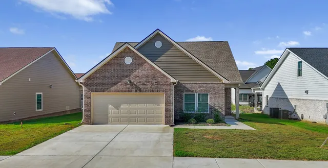 a front view of house with yard and green space