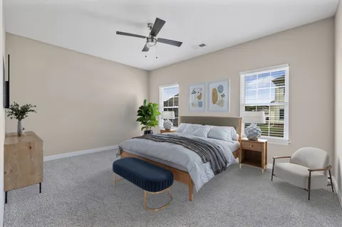 a spacious bedroom with a bed and a couch