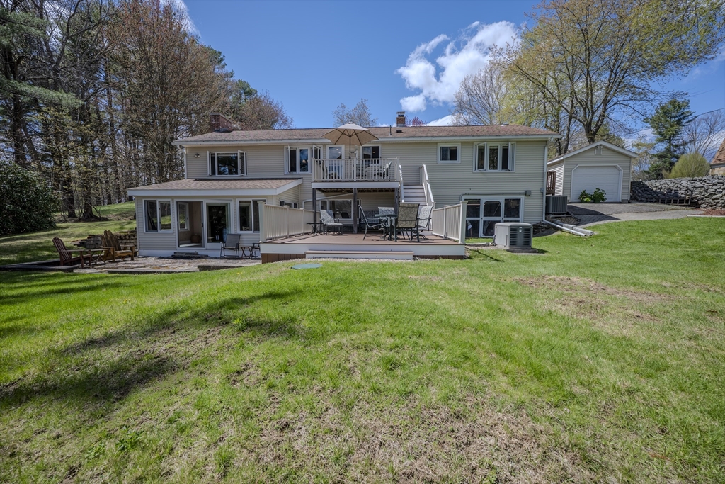 132 Paxton Road Spencer, MA 01562 - Photo 3 of 42 a view of a house with a big yard and large trees