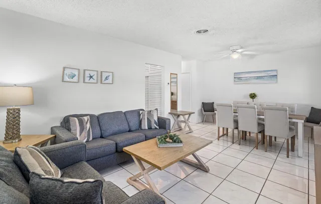 a living room with furniture a table and a lamp