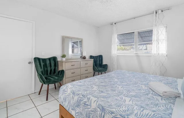 a bedroom with a bed and chair