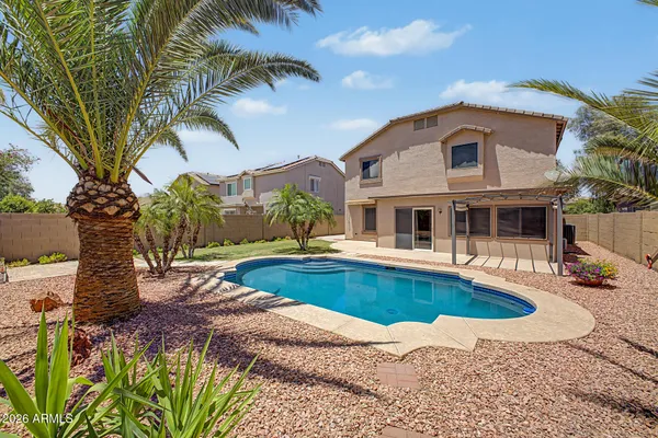 a front view of house with yard and swimming pool