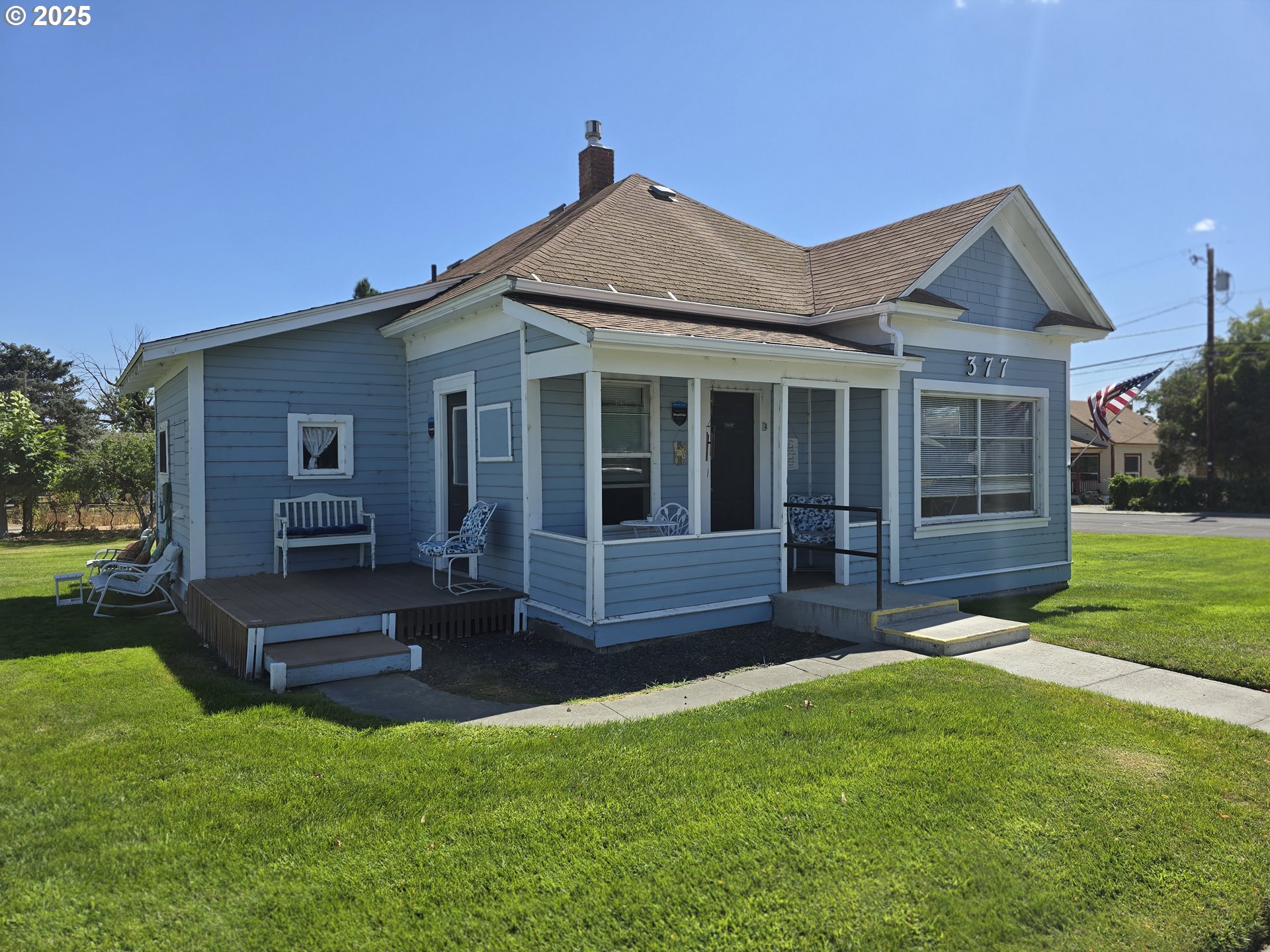 a view of a house with a yard and sitting area