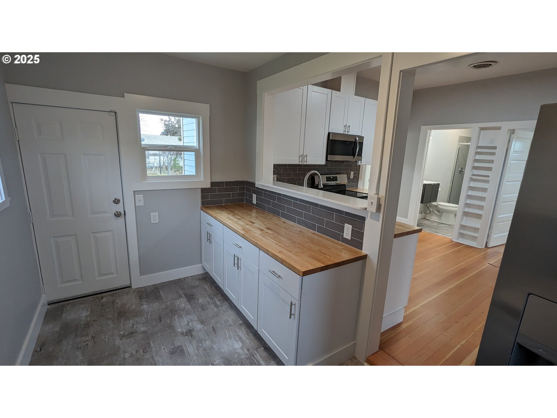 377 West Locust Avenue Hermiston, OR 97838 - Photo 12 of 16 a kitchen with cabinets and wooden floor