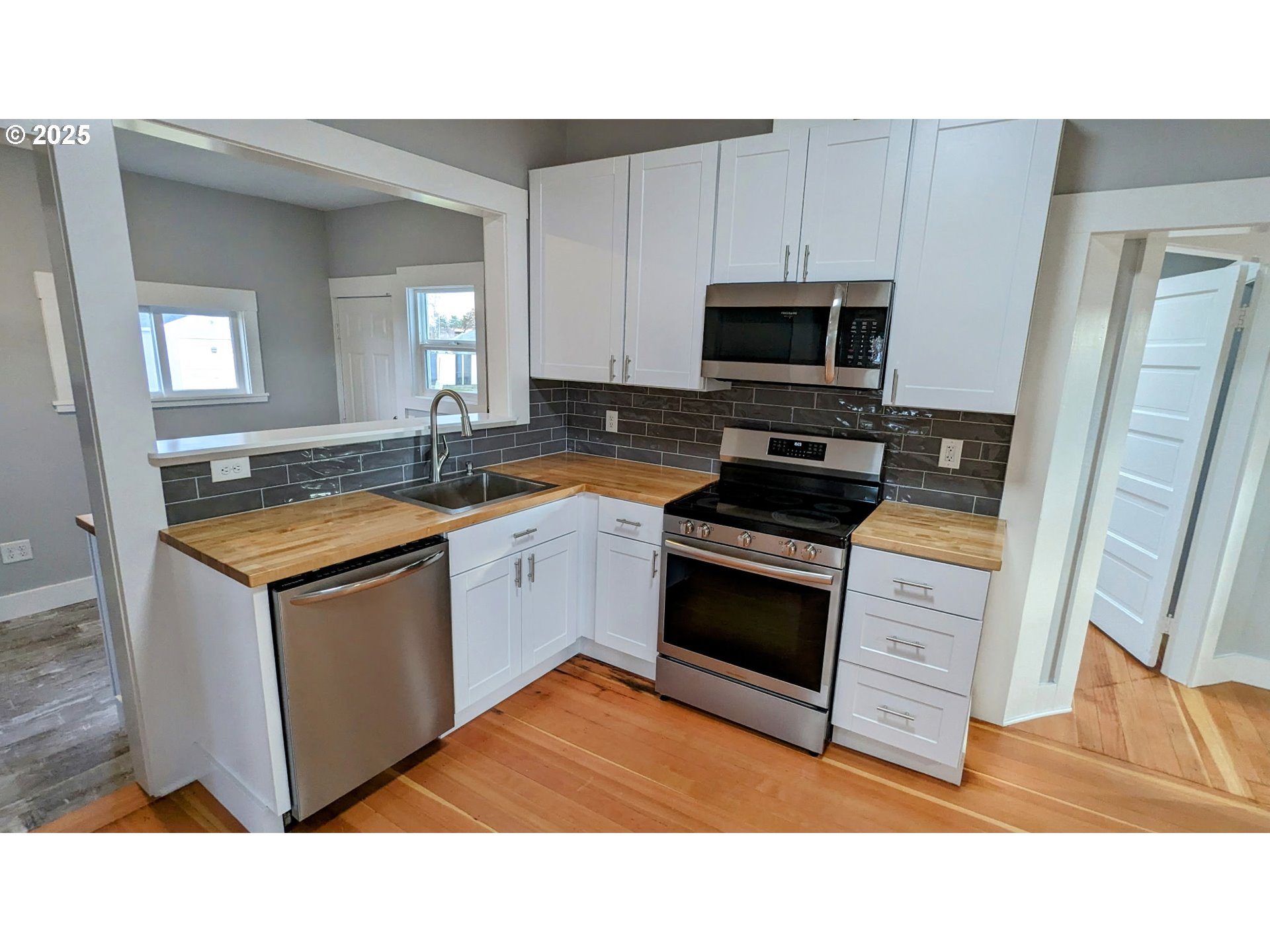 377 West Locust Avenue Hermiston, OR 97838 - Photo 10 of 16 a kitchen with stainless steel appliances granite countertop a sink stove and refrigerator