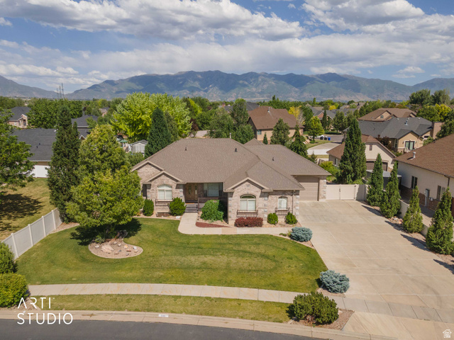 2327 Bluff Ridge Drive Syracuse, UT 84075 - Photo 56 of 66 Stone veneer exterior with an attached two-car garage and concrete driveway