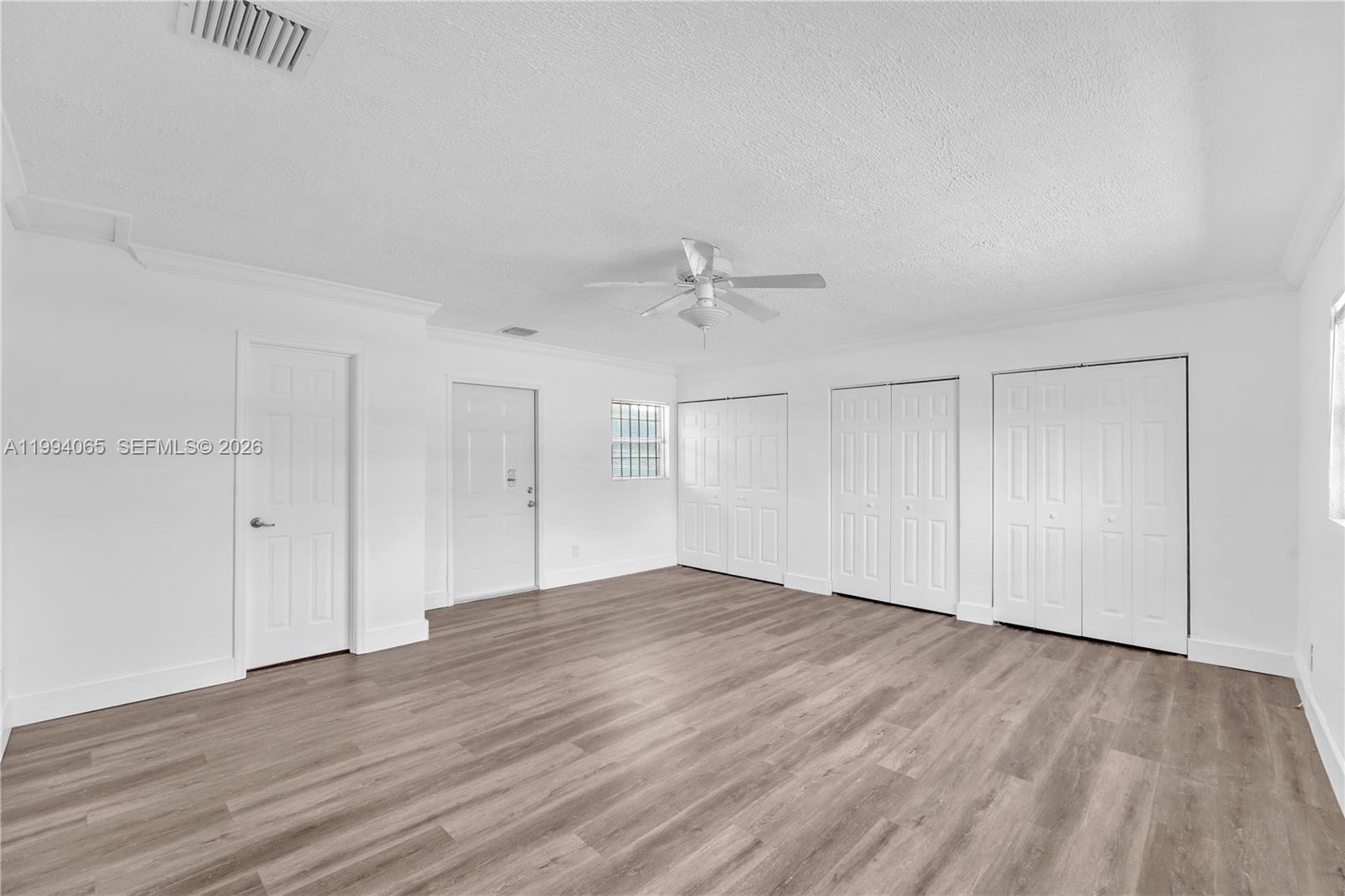 10960 Southwest 219th Street Miami, FL 33170 - Photo 12 of 22 a view of an empty room with wooden floor