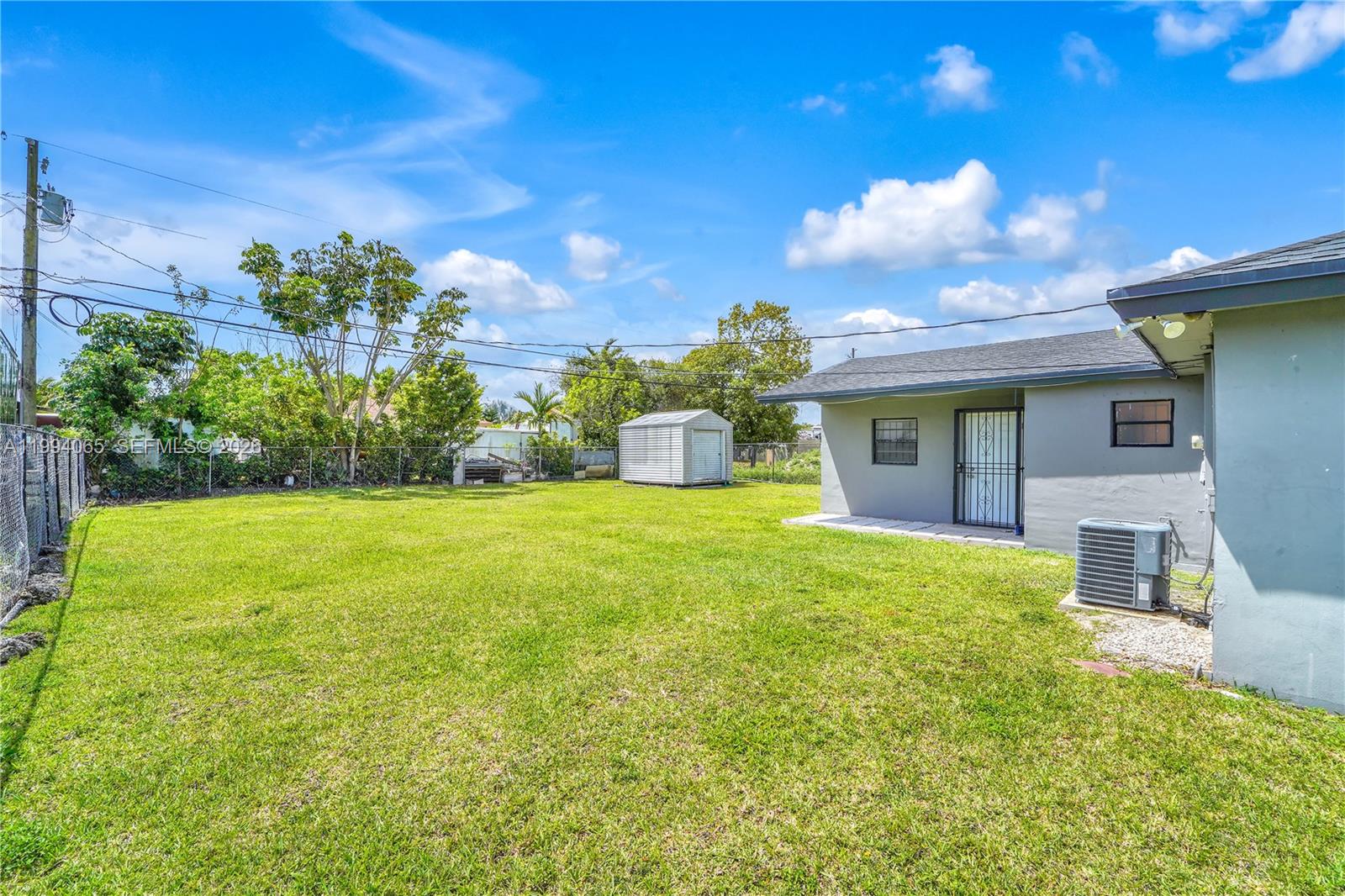 10960 Southwest 219th Street Miami, FL 33170 - Photo 19 of 22 a view of a house with a yard