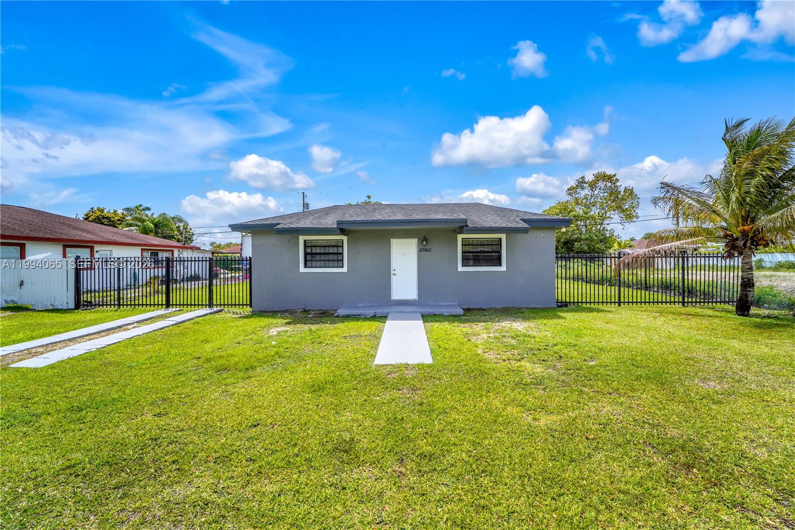 10960 Southwest 219th Street Miami, FL 33170 - Photo 3 of 22 a backyard of a house with table and chairs