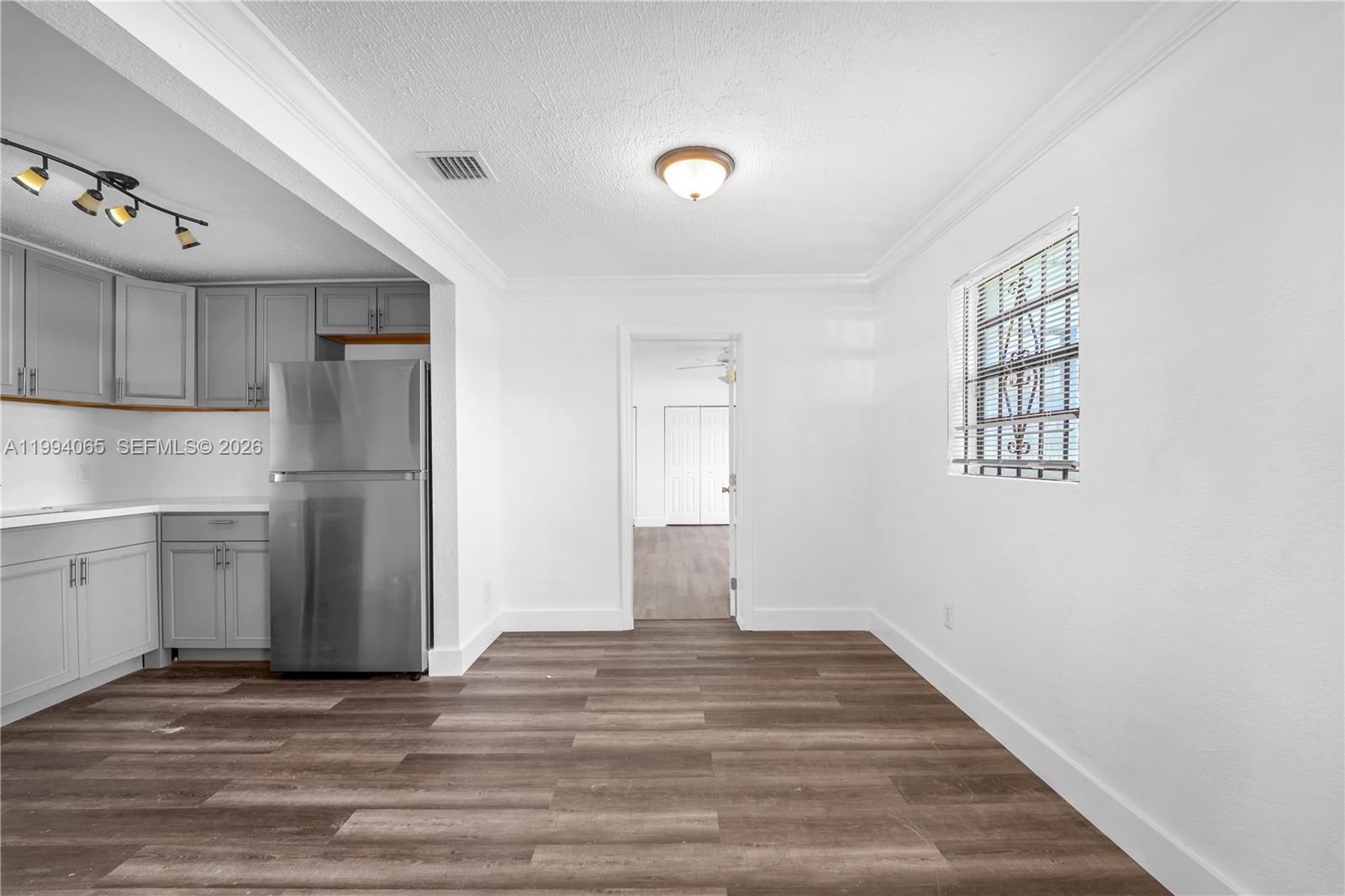 10960 Southwest 219th Street Miami, FL 33170 - Photo 7 of 22 a view of a kitchen with a sink and a refrigerator