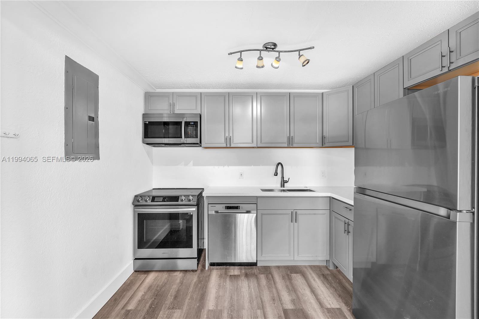 10960 Southwest 219th Street Miami, FL 33170 - Photo 10 of 22 a kitchen with a stove a sink and a refrigerator