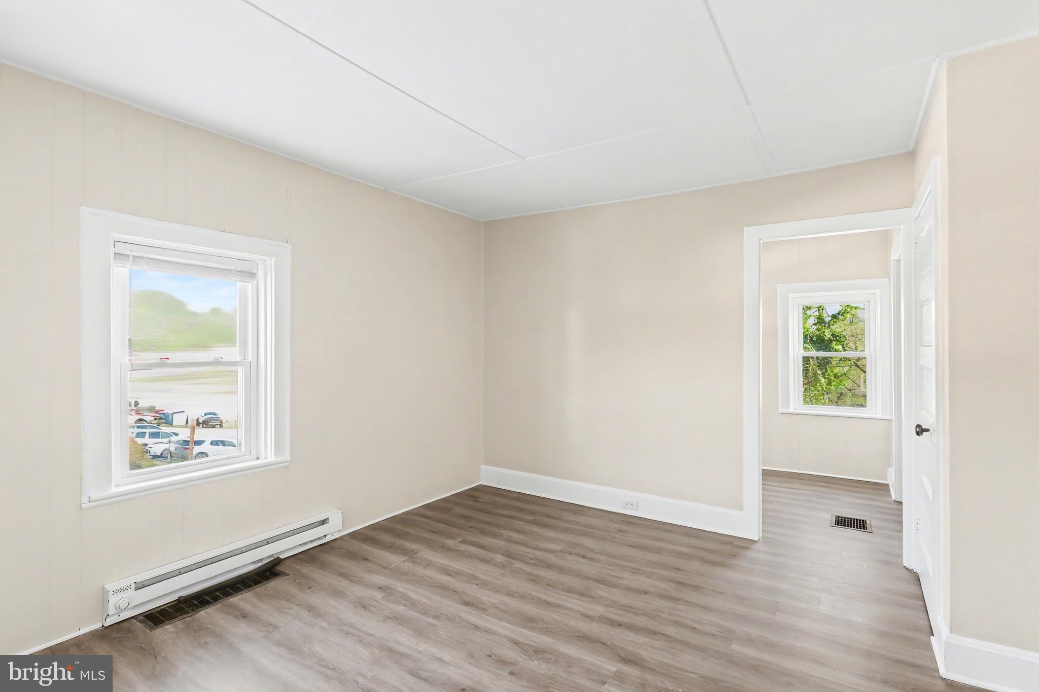 626 State Street, Unit 4 Lemoyne, PA 17043 - Photo 5 of 8 an empty room with window and wooden floor