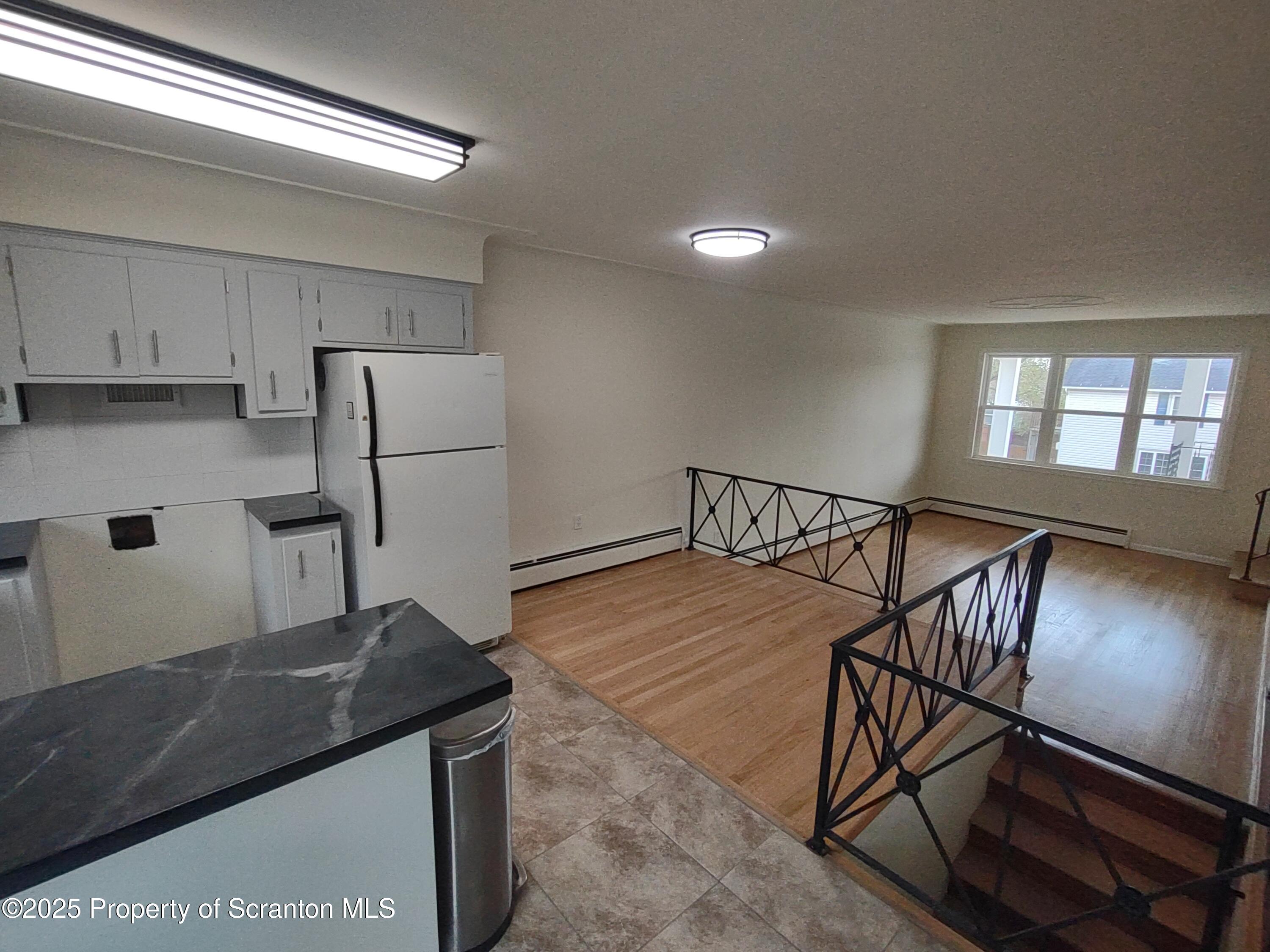 1104 Filbert Street Archbald, PA 18403 - Photo 14 of 39 a kitchen with stainless steel appliances granite countertop a refrigerator a stove a sink and a refrigerator