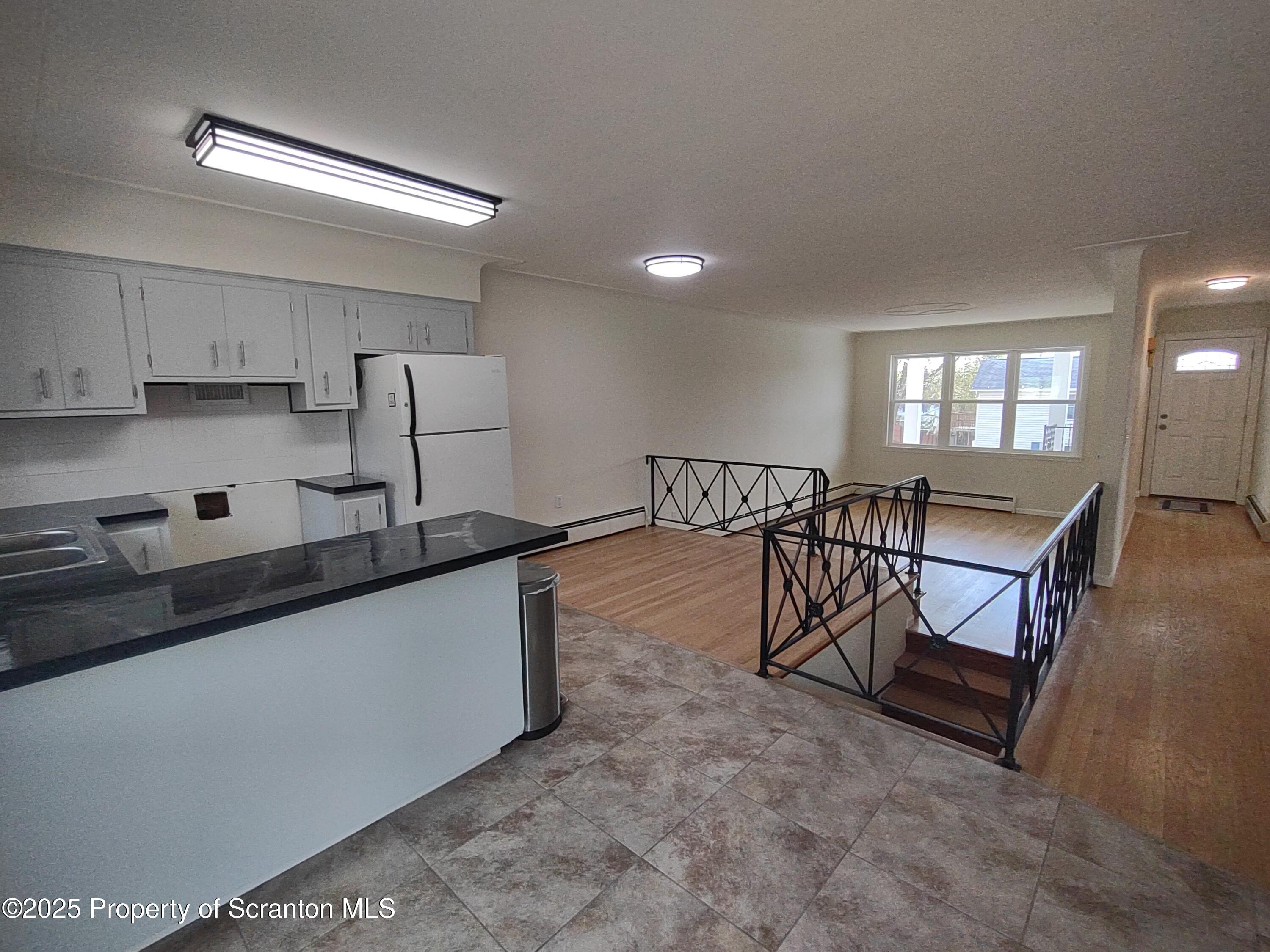 1104 Filbert Street Archbald, PA 18403 - Photo 15 of 39 a kitchen with stainless steel appliances granite countertop a stove a sink a refrigerator and white cabinets