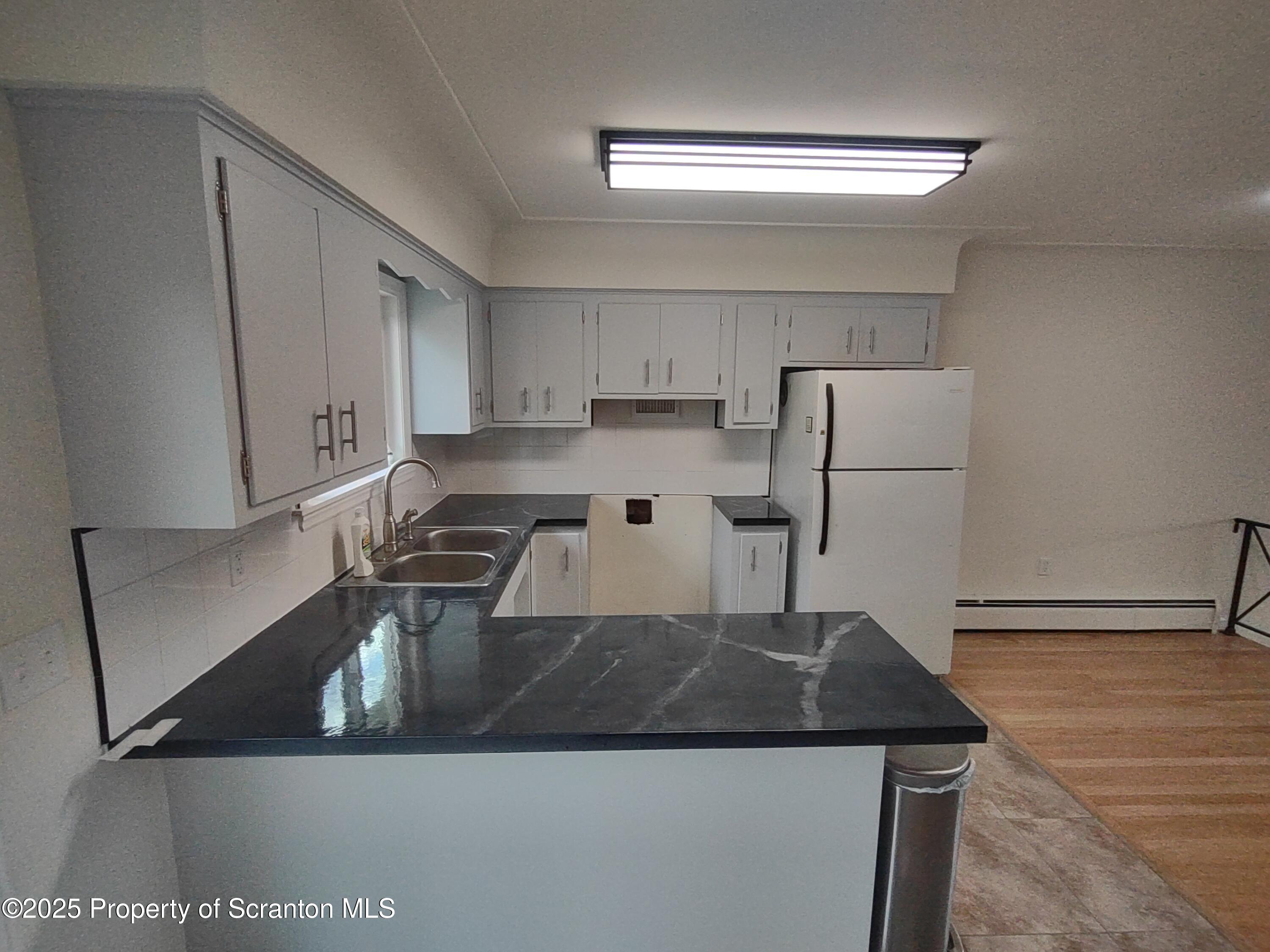 1104 Filbert Street Archbald, PA 18403 - Photo 16 of 39 a kitchen with stainless steel appliances granite countertop a sink a refrigerator and a stove
