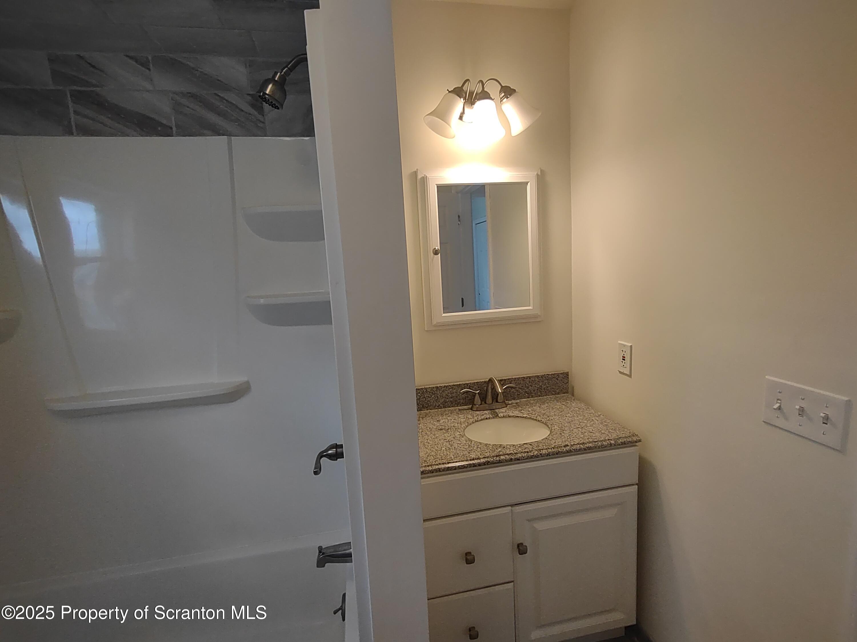 1104 Filbert Street Archbald, PA 18403 - Photo 21 of 39 a bathroom with a granite countertop sink toilet and vanity