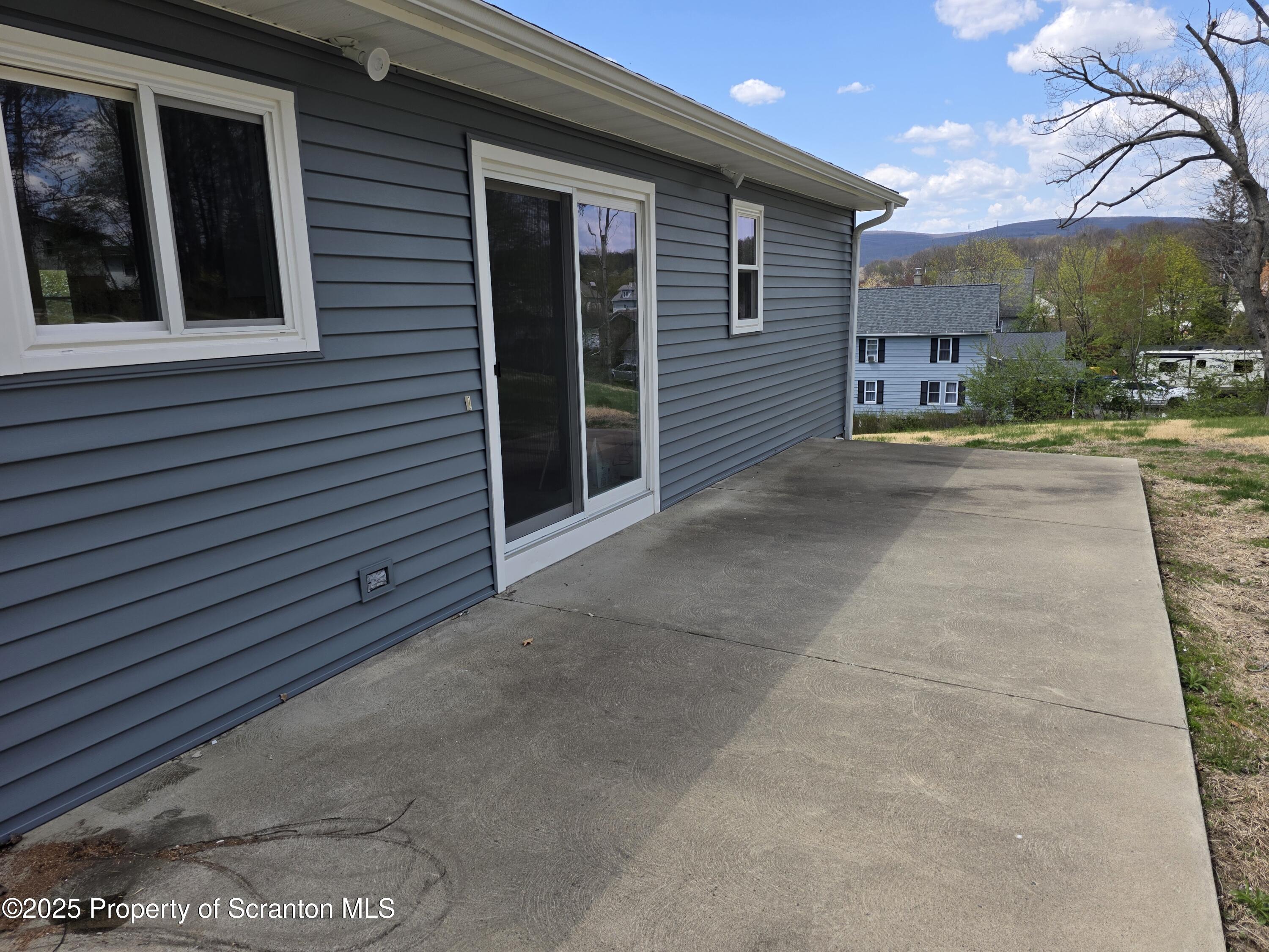 1104 Filbert Street Archbald, PA 18403 - Photo 28 of 39 a view of a brick house with a yard