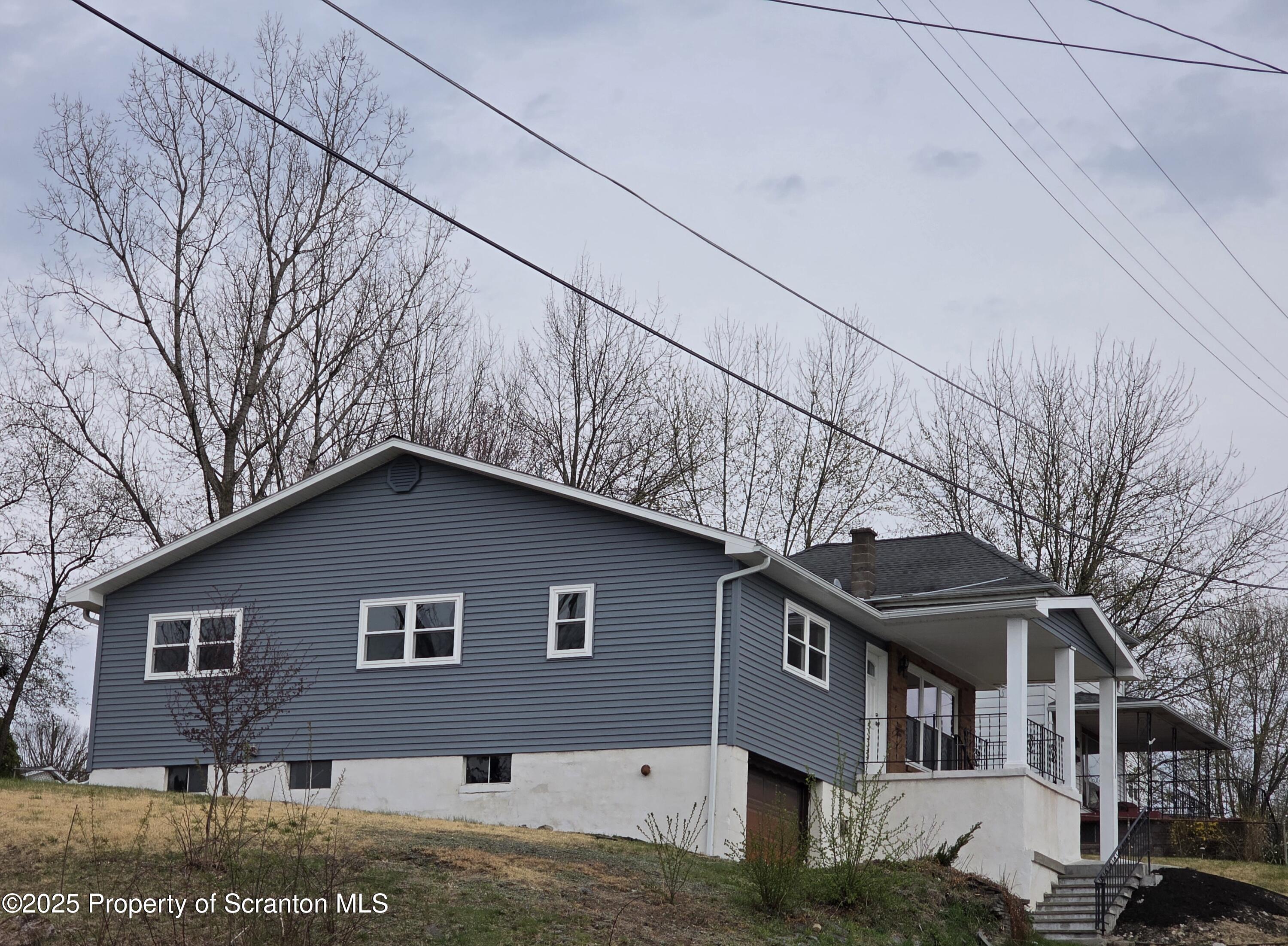 1104 Filbert Street Archbald, PA 18403 - Photo 30 of 39 a front view of a house with a yard