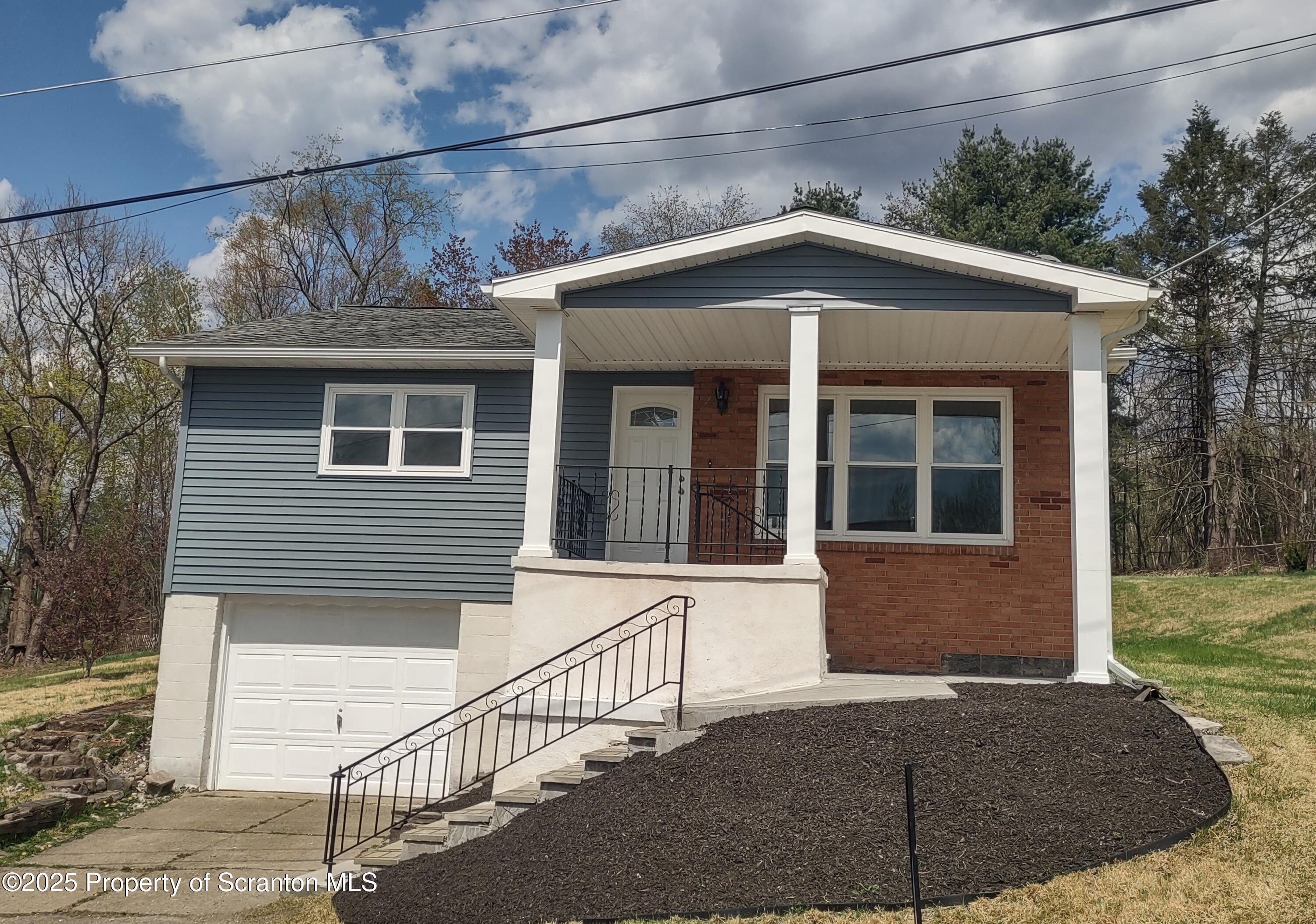 1104 Filbert Street Archbald, PA 18403 - Photo 4 of 39 a front view of a house with garage