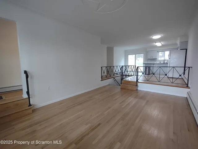 a view of a room with lots of wooden furniture