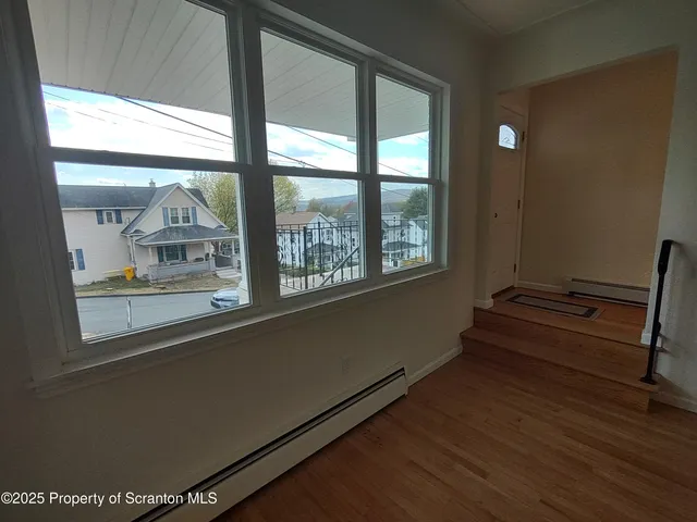 a room with wooden floor and a window