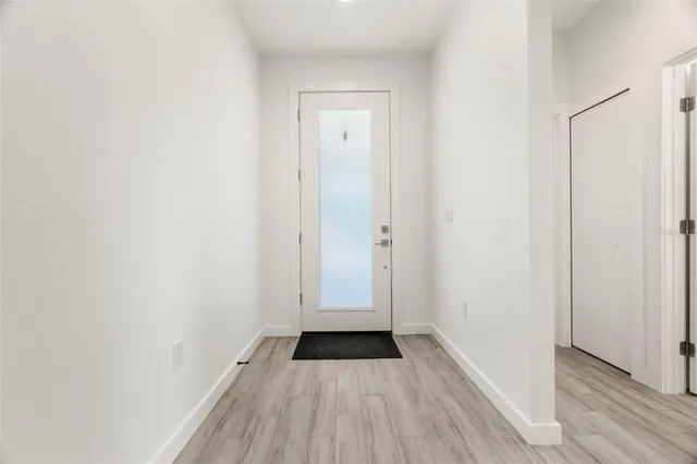 a view of a small space with wooden floor and a sink
