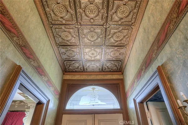 a dining room with wooden floor and chandelier