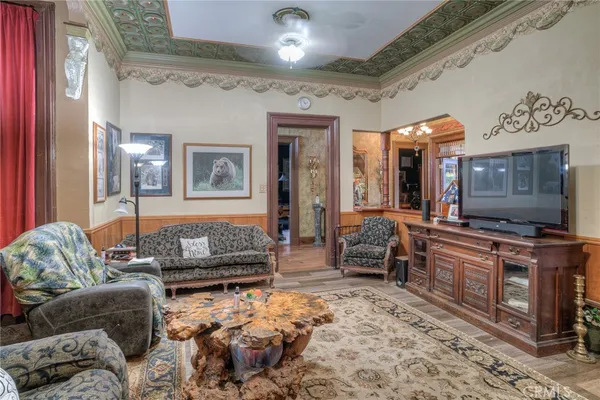 a view of a dining room with furniture and chandelier
