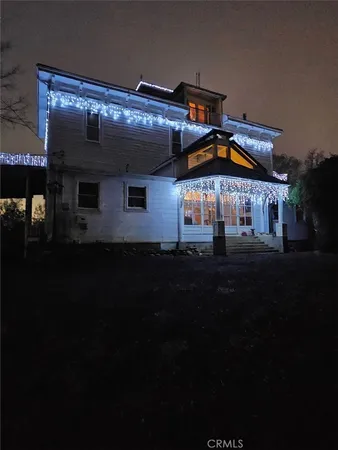 a front view of house with yard and outdoor seating