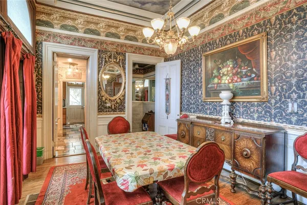 a view of a hallway with furniture and chandelier