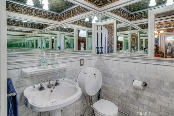 a bathroom with a sink mirror and toilet