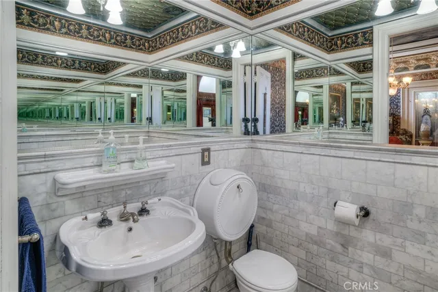 a bathroom with a sink mirror and toilet
