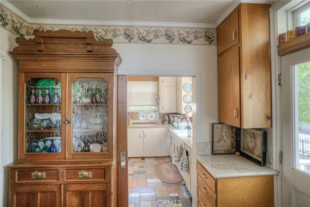 a living room with furniture a fireplace and dining table