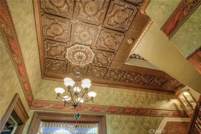 a view of a hallway with wooden floor and a window