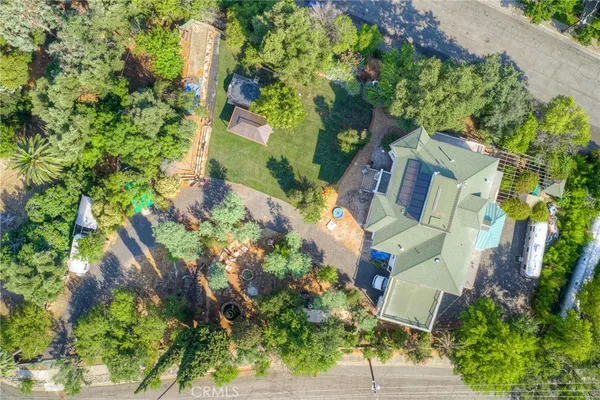 an aerial view of residential houses with outdoor space and street view