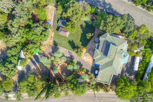 an aerial view of residential houses with outdoor space and street view