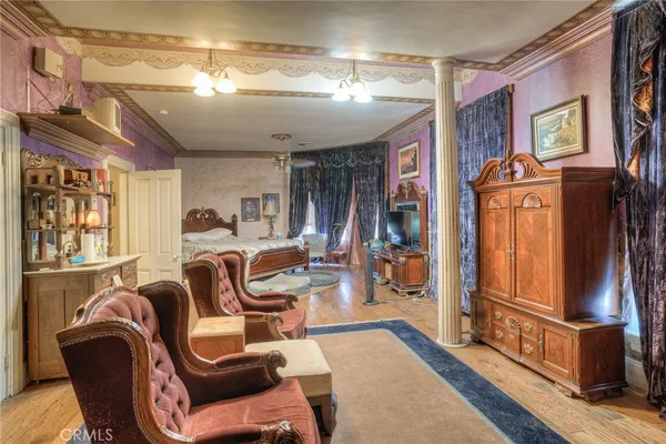 a bedroom with a bed and a chandelier
