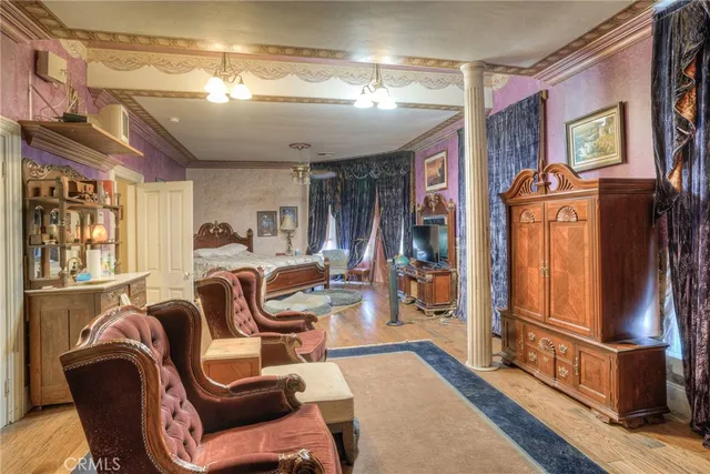 a bedroom with a bed and a chandelier