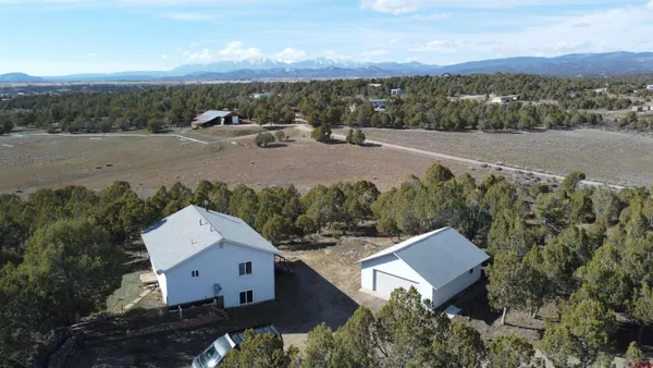 an aerial view of a house with a yard