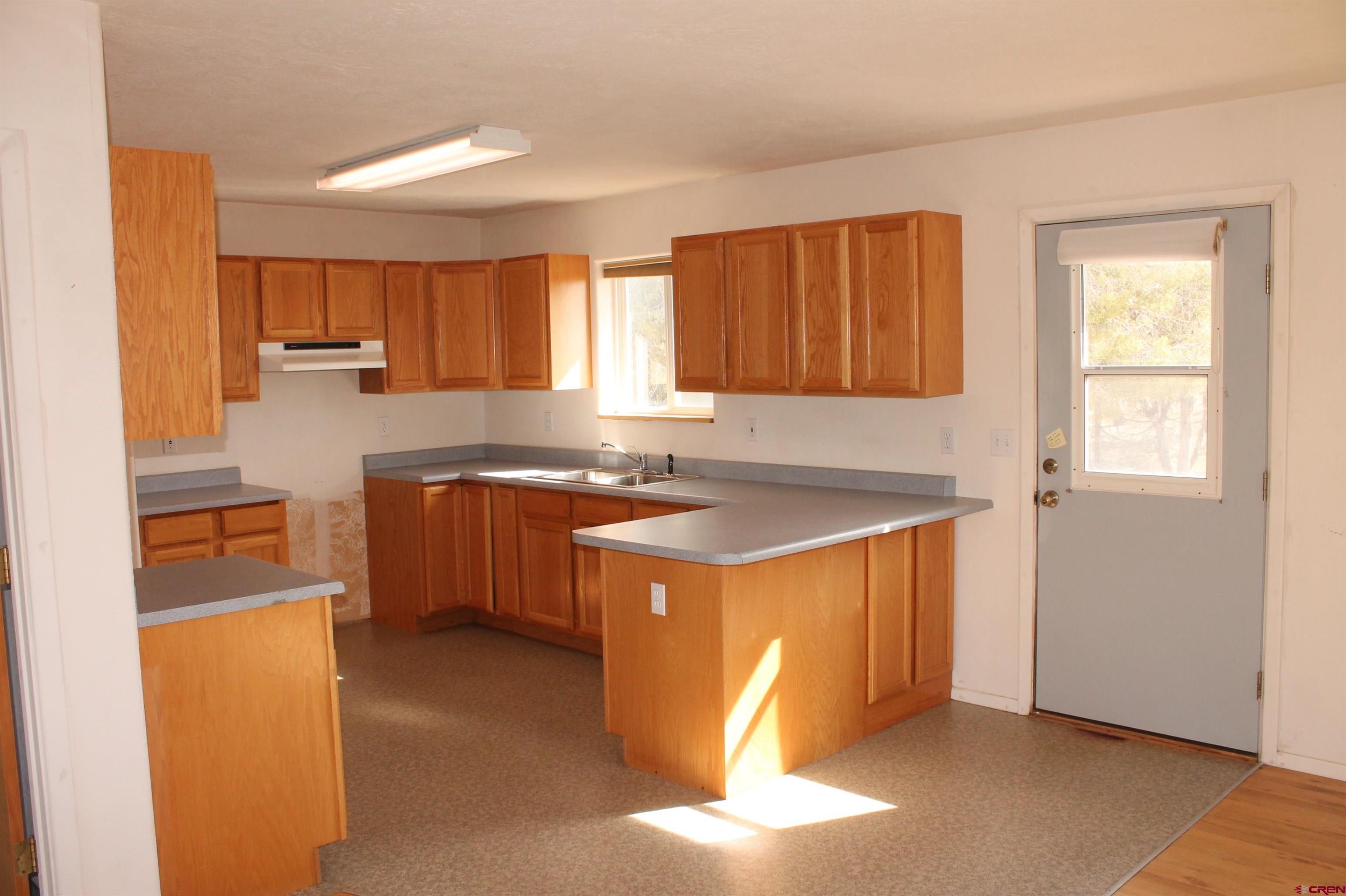 2944 County Road 510 Durango, CO 81303 - Photo 11 of 38 a kitchen with stainless steel appliances granite countertop a sink stove and refrigerator